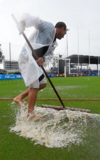 A groundsman tries to deal with the surface water in Mackay. Picture: Getty Images - ${keywords}